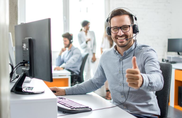 Man with Glasses on Computer Giving Thumbs Up