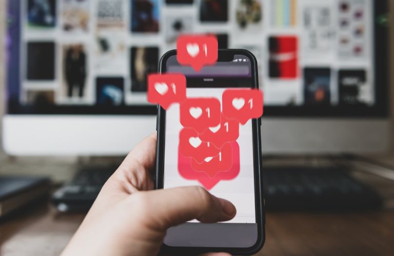 Smartphone with Many Red Social Media Hearts