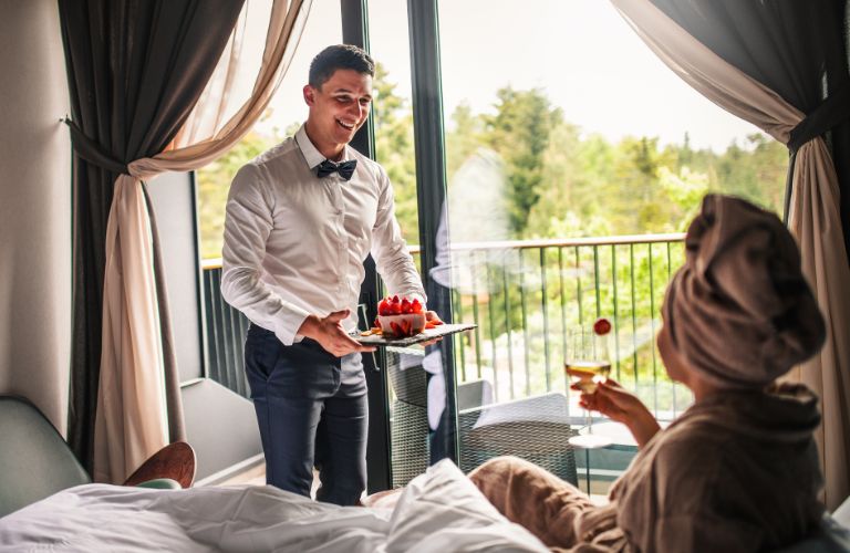 Waiter Bringing Room Service to a Woman