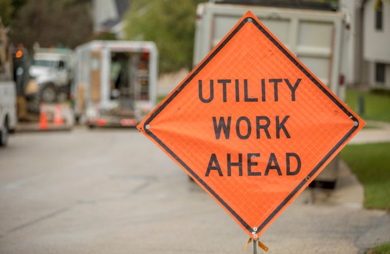 Orange Utility Work Ahead Sign on a Street
