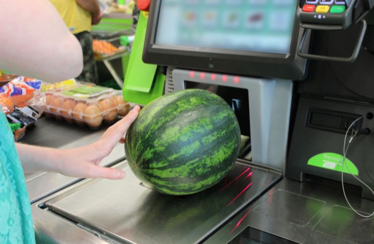 Customer Using Self-Checkout to Buy a Watermelon