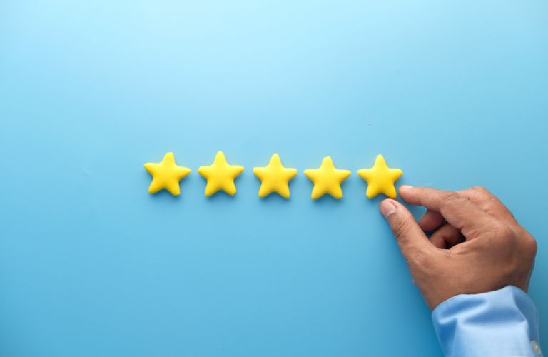 Blue Background with Man Putting Up 5-Stars